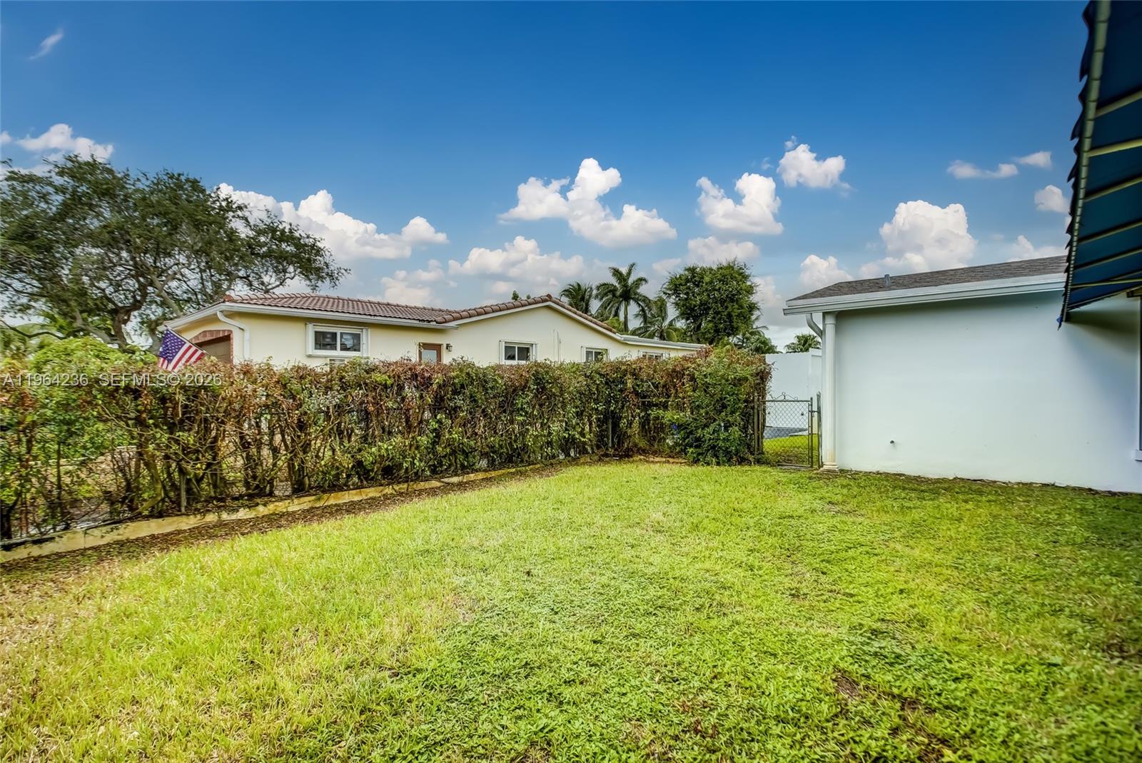 4917 West Park Road Hollywood, FL 33021 - Photo 21 of 25 a view of a house with a yard and a garden
