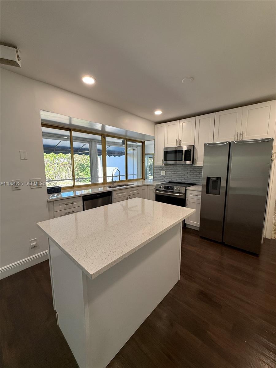 4917 West Park Road Hollywood, FL 33021 - Photo 8 of 25 a large white kitchen with a large window