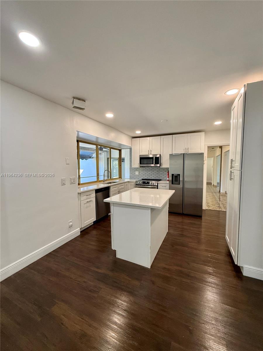 4917 West Park Road Hollywood, FL 33021 - Photo 10 of 25 a large kitchen with a lot of counter top space stainless steel appliances and a window