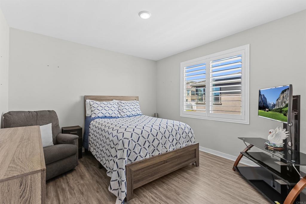 29809 Gypsy Vanner Way Menifee, CA 92584 - Photo 27 of 45 a bedroom with bed couch and a window