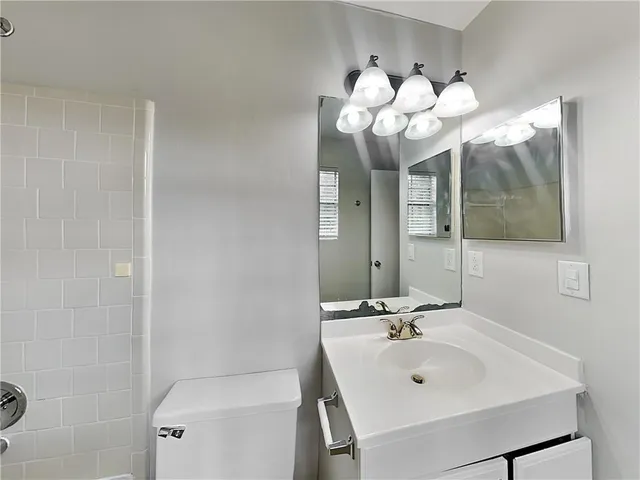 a bathroom with a sink mirror and vanity