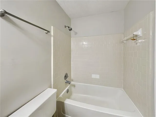 a white bath tub with a shower