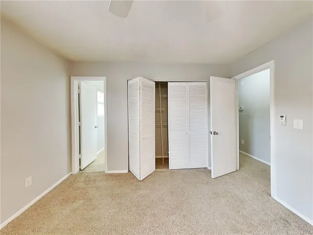 a view of an empty room and closet area