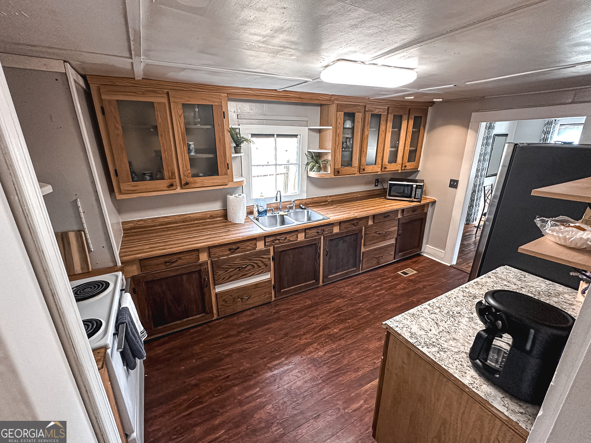 3305 Cherokee Avenue Columbus, GA 31906 - Photo 11 of 49 a kitchen with stainless steel appliances granite countertop a stove and a refrigerator