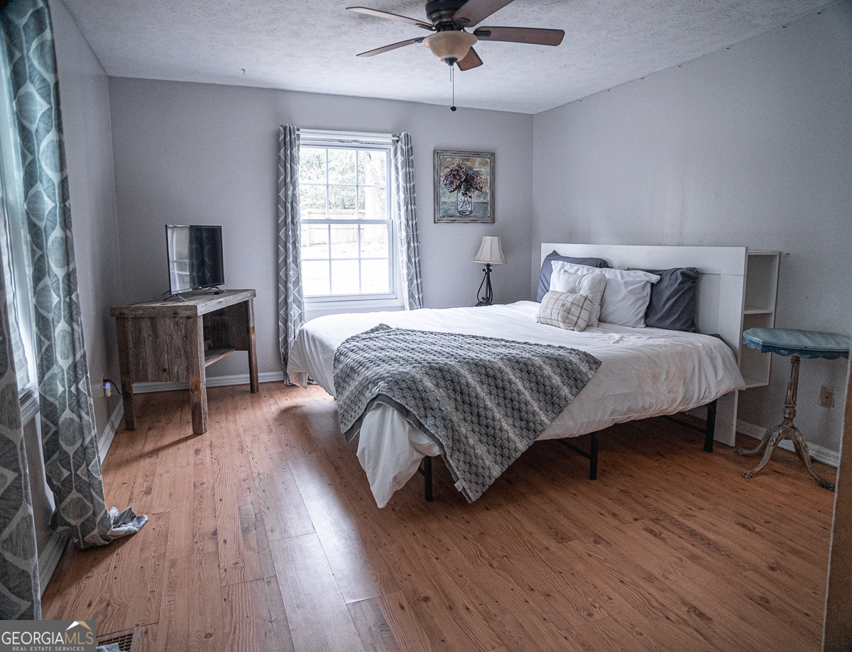 3305 Cherokee Avenue Columbus, GA 31906 - Photo 14 of 49 a bedroom with a bed and wooden floor