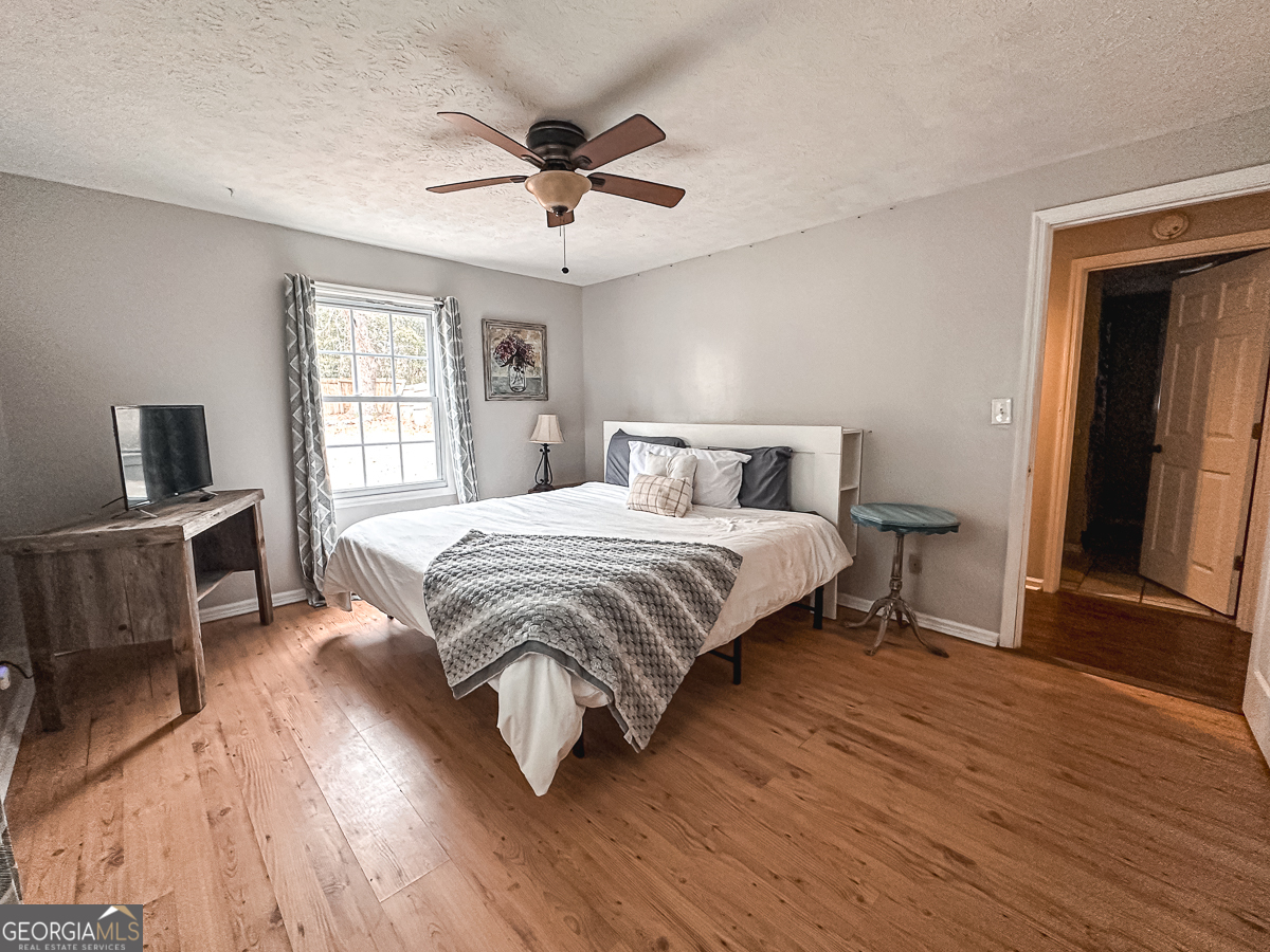 3305 Cherokee Avenue Columbus, GA 31906 - Photo 18 of 49 a bedroom with a large bed a flat tv screen and dresser