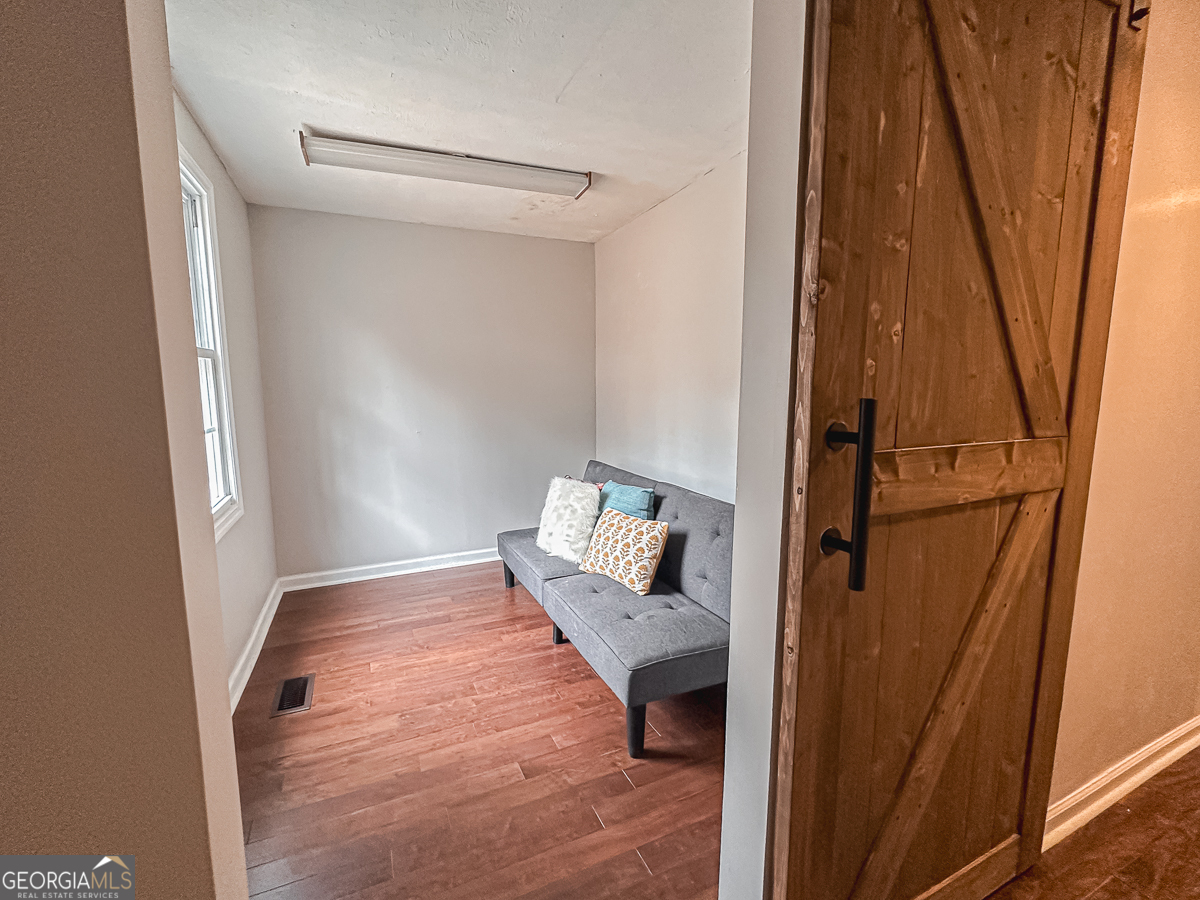 3305 Cherokee Avenue Columbus, GA 31906 - Photo 22 of 49 a view of a hallway with wooden floor and stairs