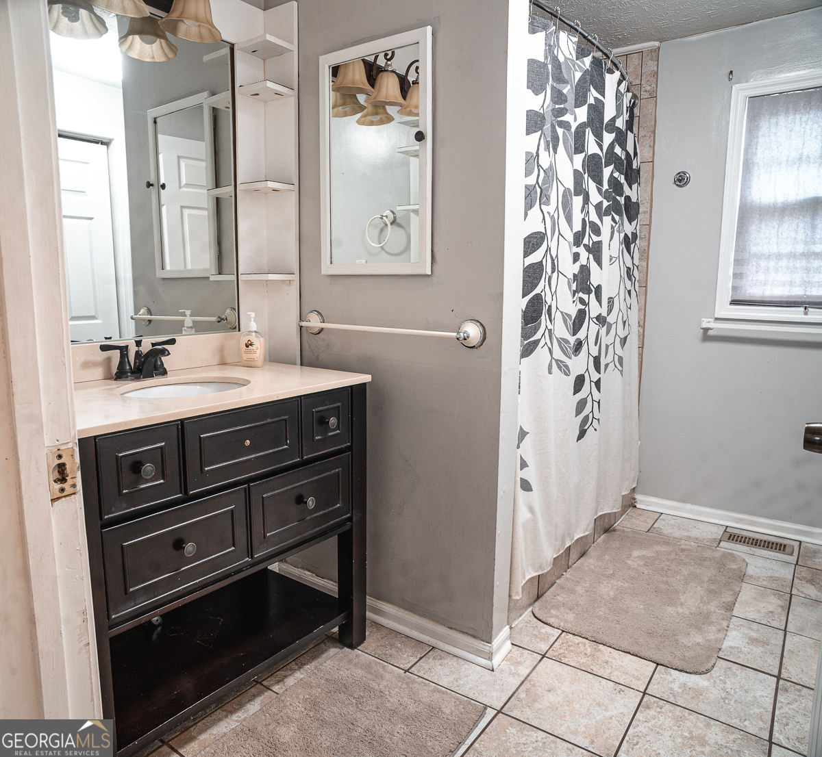 3305 Cherokee Avenue Columbus, GA 31906 - Photo 24 of 49 a bathroom with a sink a mirror and a shower