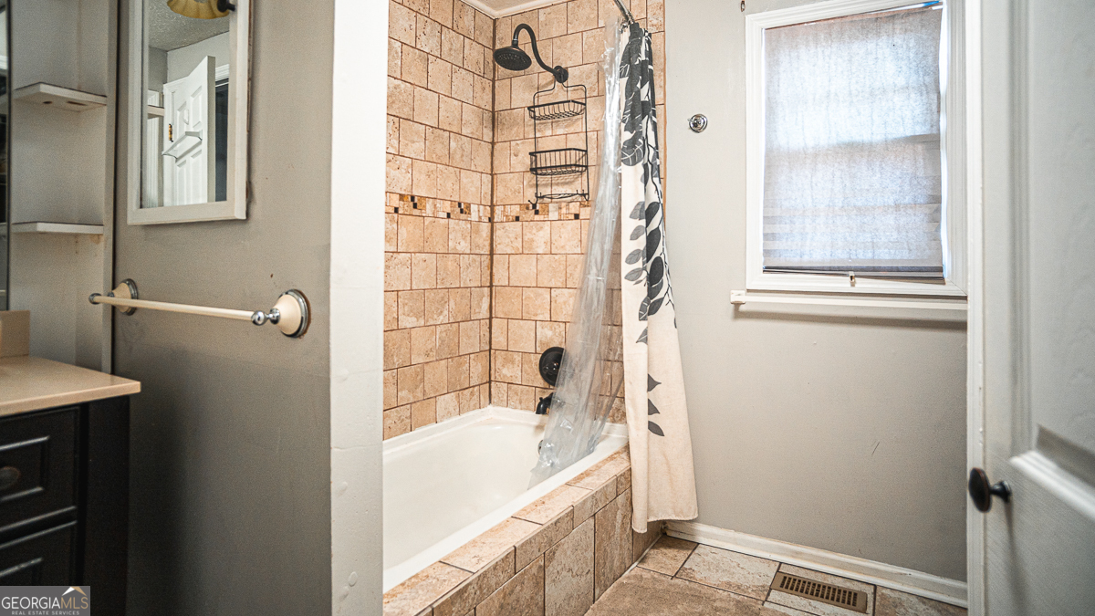 3305 Cherokee Avenue Columbus, GA 31906 - Photo 35 of 49 a bathroom with a bathtub and a shower