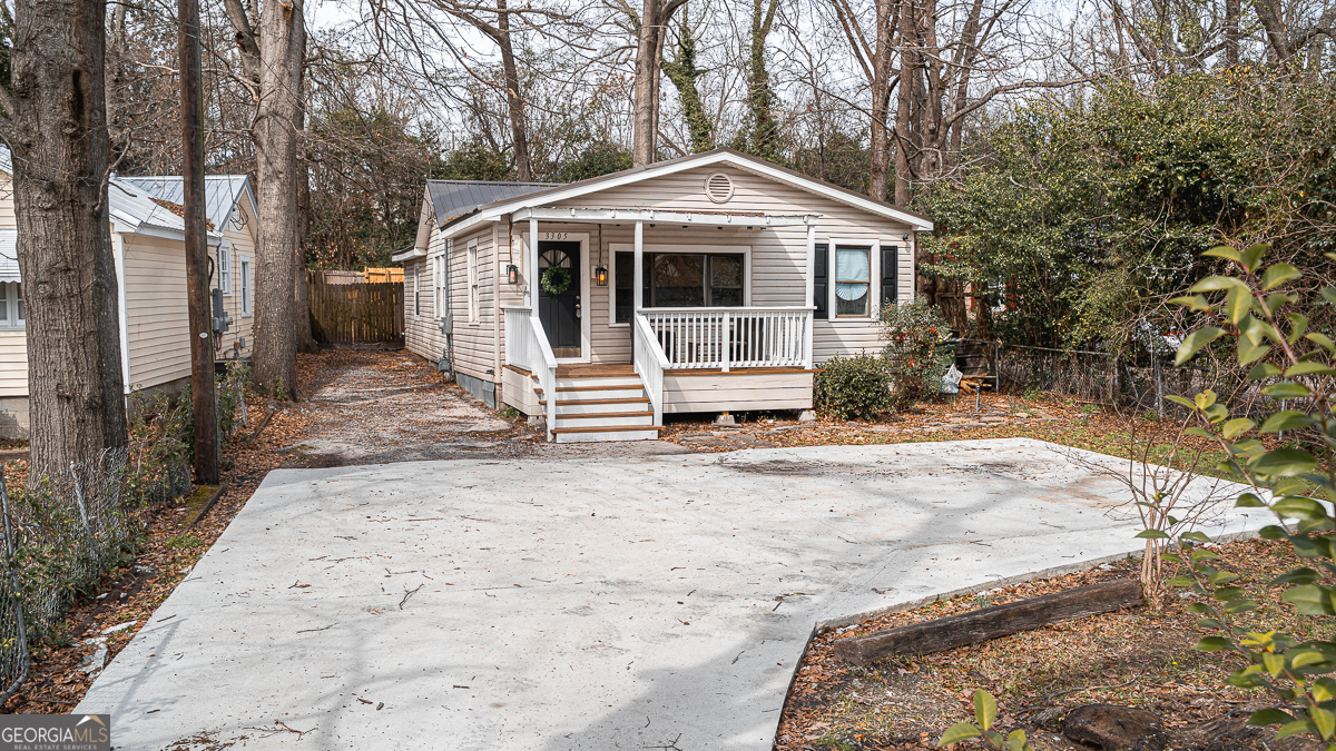 3305 Cherokee Avenue Columbus, GA 31906 - Photo 43 of 49 a front view of a house with a yard covered in snow