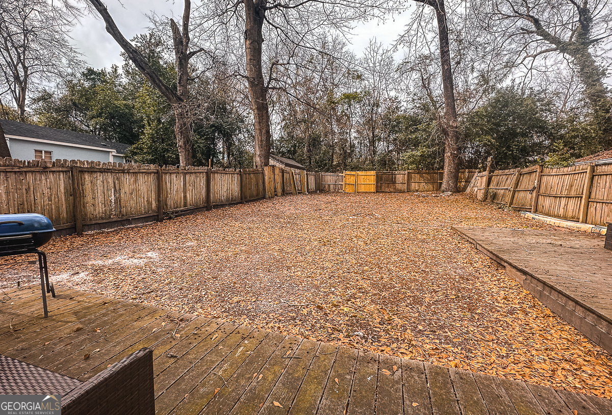 3305 Cherokee Avenue Columbus, GA 31906 - Photo 48 of 49 a backyard of a house with large trees and wooden fence