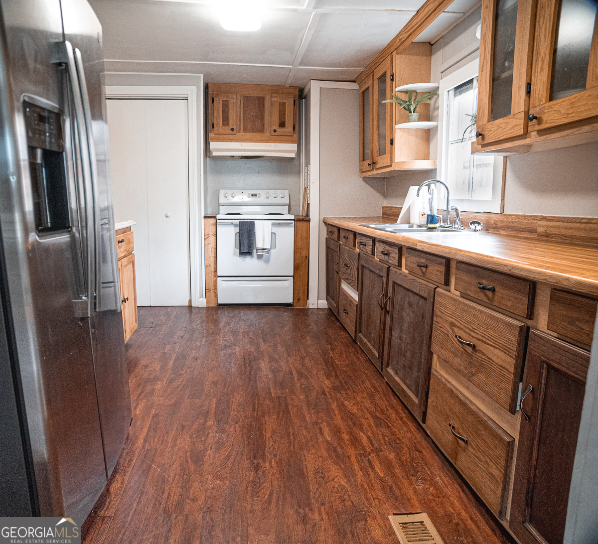 3305 Cherokee Avenue Columbus, GA 31906 - Photo 8 of 49 a kitchen with stainless steel appliances a refrigerator and wooden floor