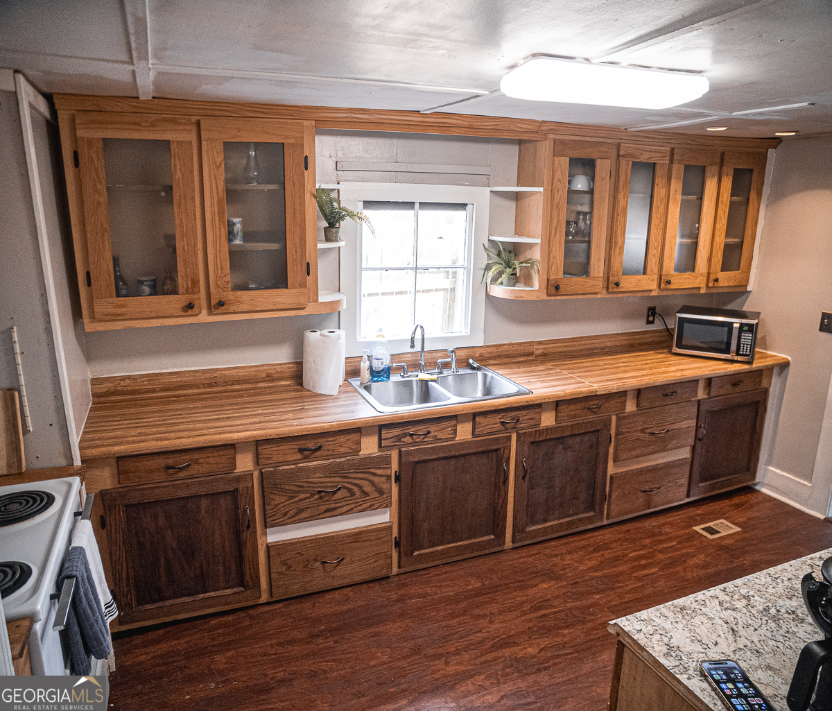 3305 Cherokee Avenue Columbus, GA 31906 - Photo 10 of 49 a kitchen with stainless steel appliances granite countertop a sink stove and wooden floor