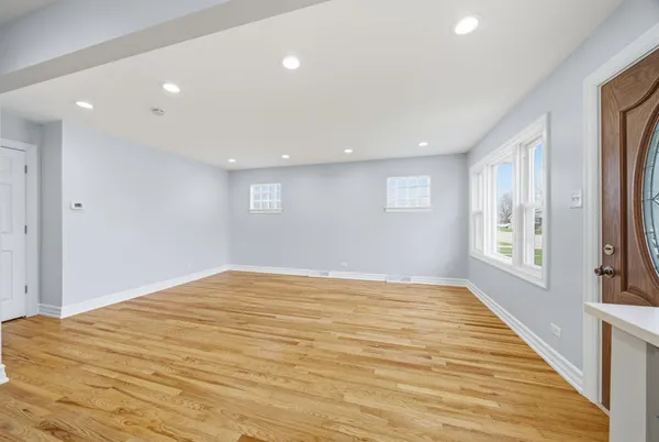 a large kitchen with cabinets wooden floor and stainless steel appliances