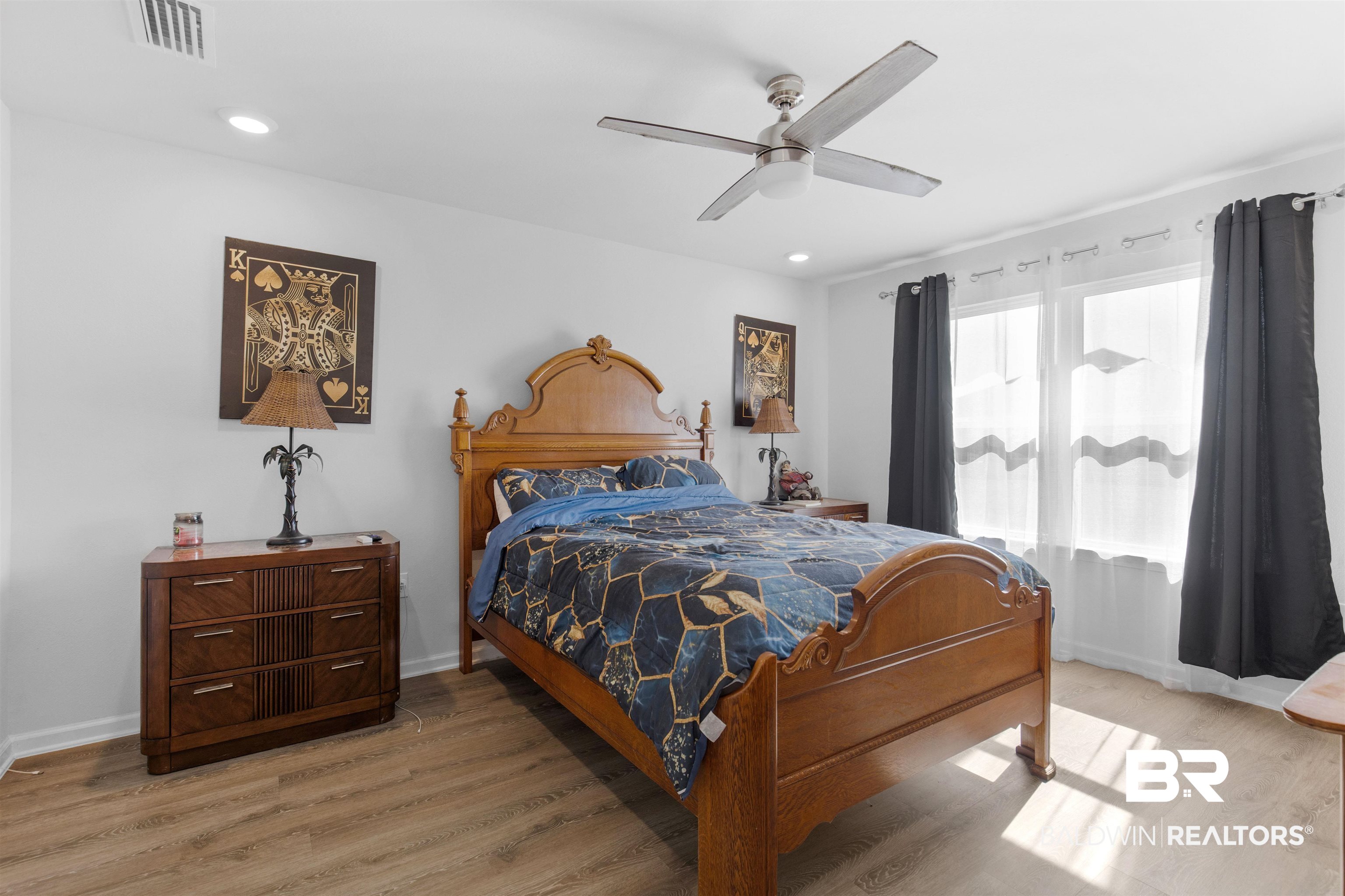 10261 Ruffian Route Daphne, AL 36526 - Photo 11 of 28 Bedroom with visible vents, baseboards, light wood-type flooring, and a ceiling fan