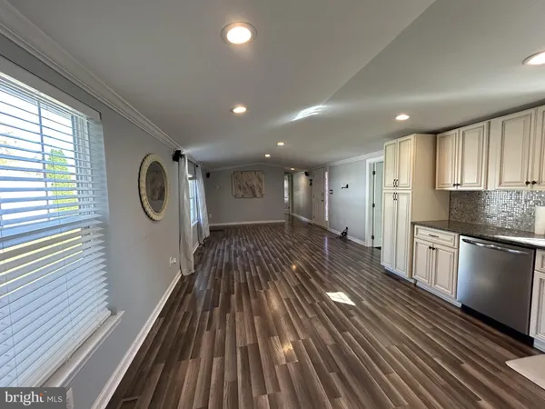 a view of kitchen with granite countertop stainless steel appliances counter space and a window