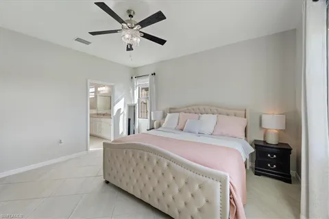 a bedroom with a bed and a ceiling fan