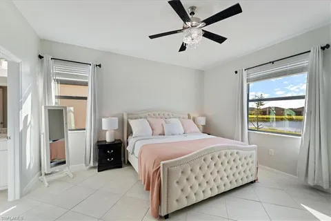 a bedroom with a bed and a large window