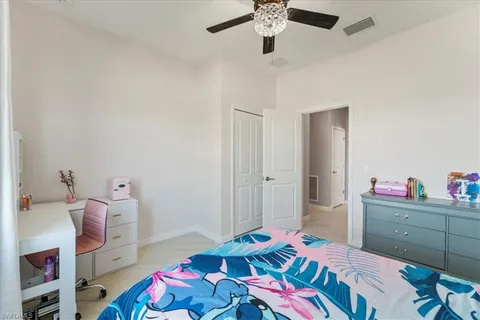 a bedroom with a bed and a wooden floor