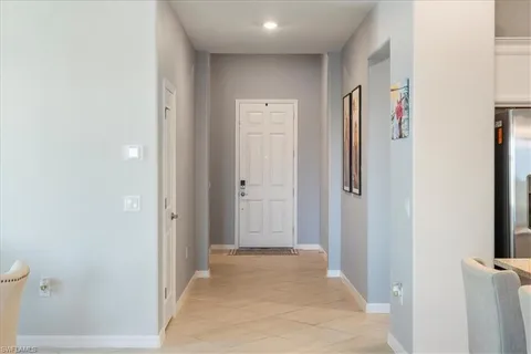 a view of a hallway with wooden floor and closet