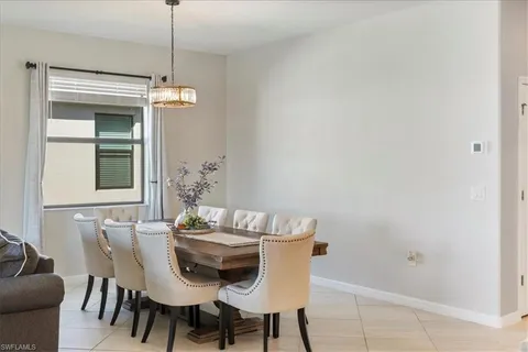 a view of a dining room that has a dining table and chairs
