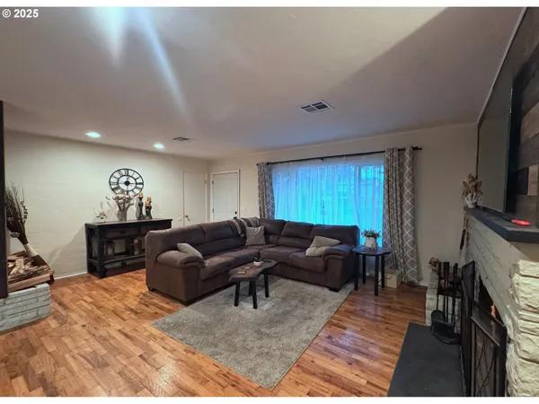 a living room with furniture a window and a flat screen tv