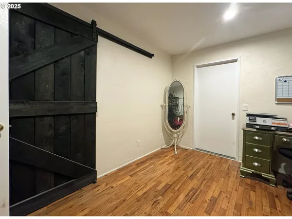 a view of a room with wooden floor and cabinet