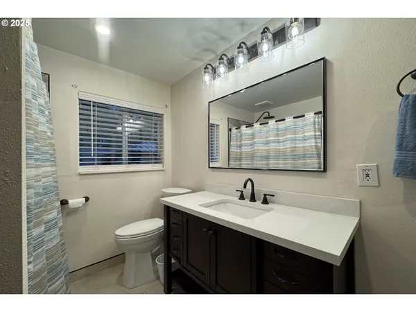 a bathroom with a sink vanity and a mirror