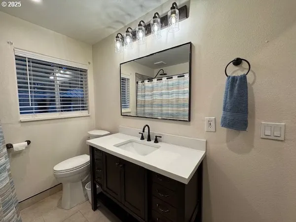 a bathroom with a sink a toilet and mirror