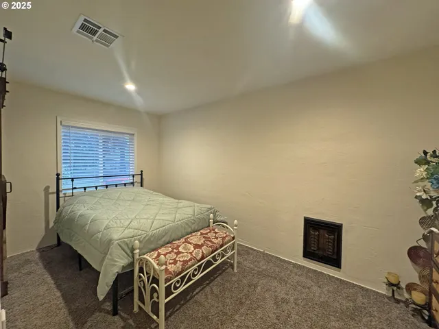 a bed sitting in a room next to a window