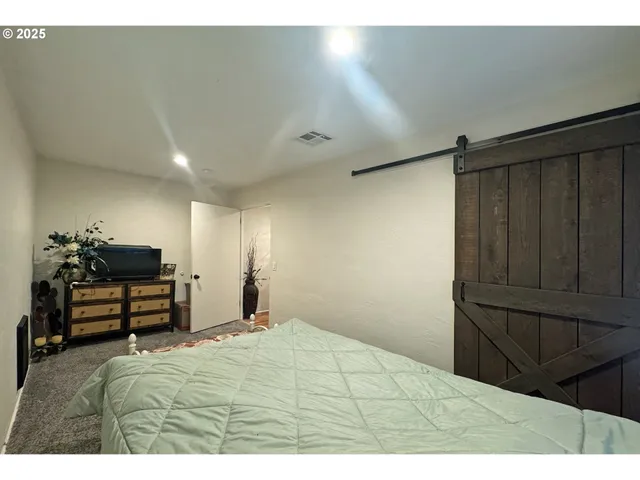 a bedroom with a bed and a dresser