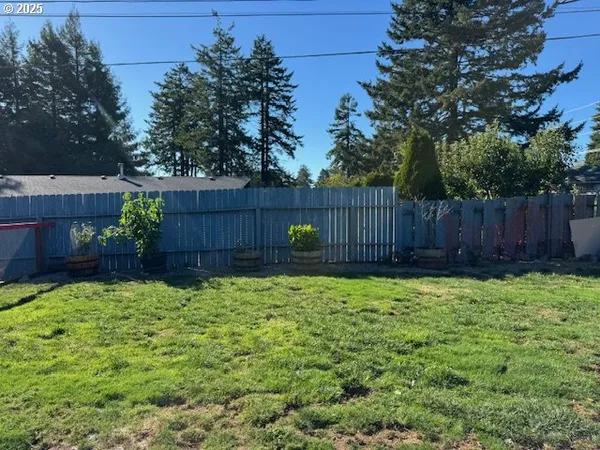 a view of garden with wooden fence