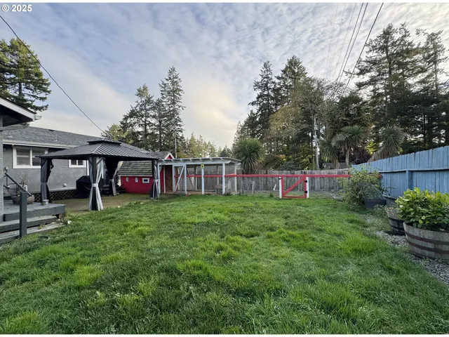 a view of a house with a backyard and sitting area
