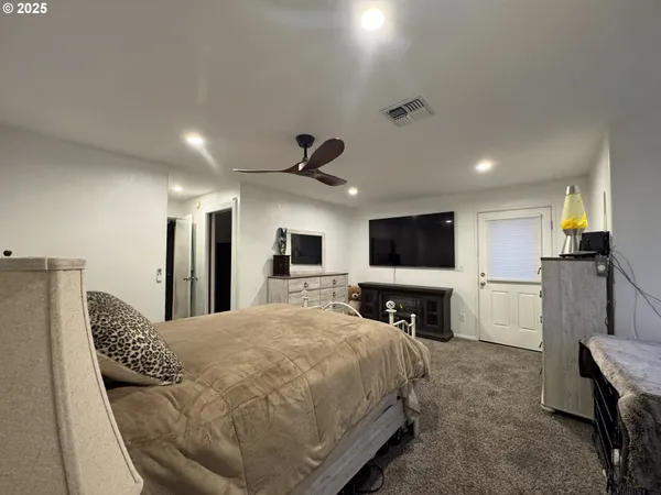 a bedroom with a bed and a television