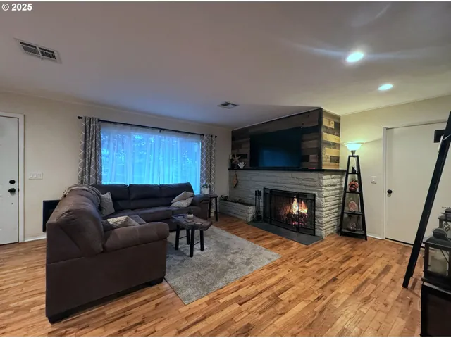 a living room with furniture and a fireplace