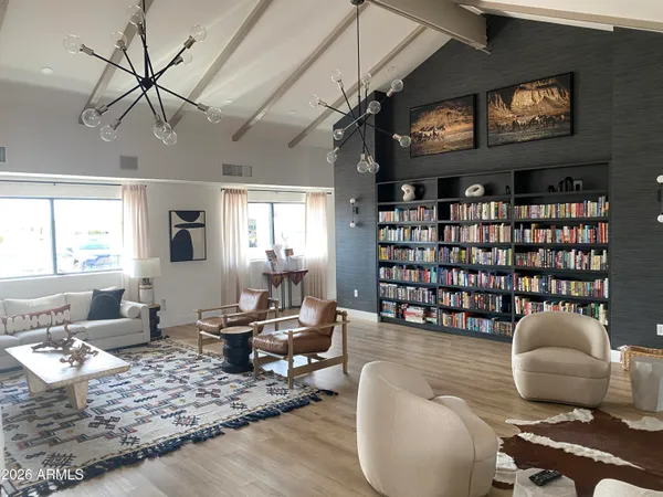 a living room with furniture a rug and white walls