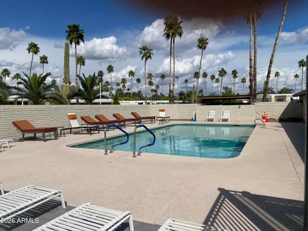 a view of a swimming pool with outdoor seating