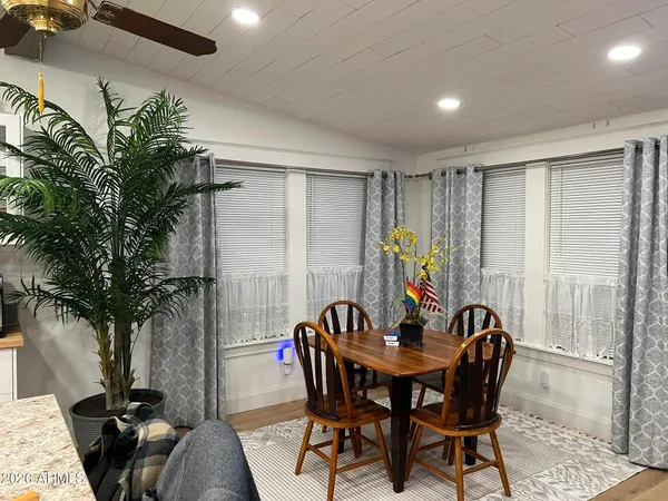 a view of a dining room with furniture and window