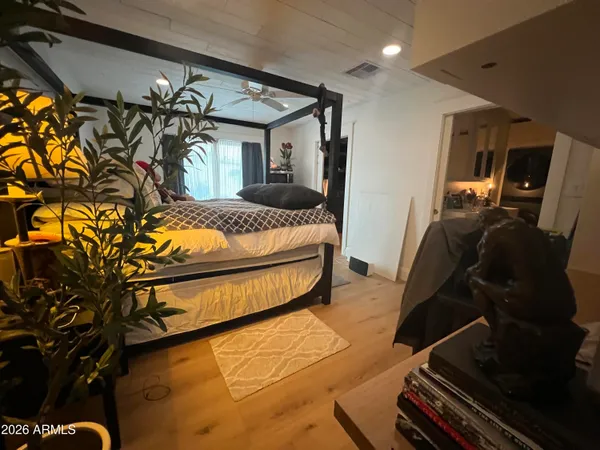 a bedroom with a bed and a ceiling fan