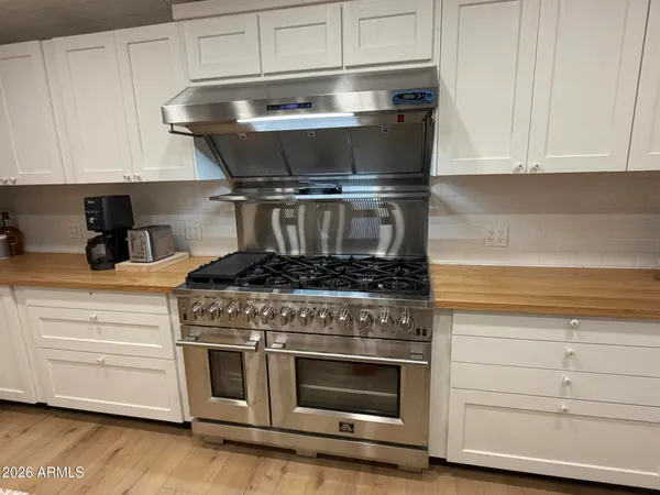 a stove top oven sitting inside of a kitchen