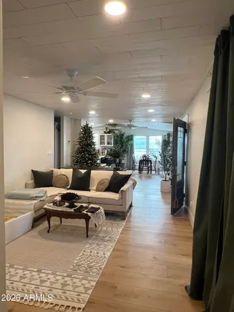 a living room with furniture and wooden floor