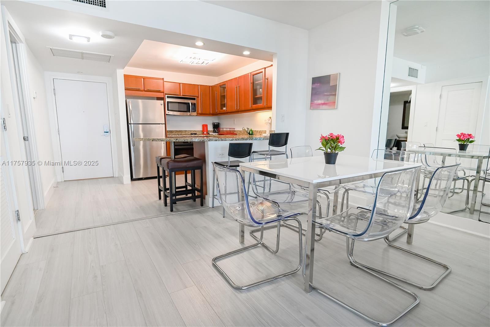 2301 Collins Avenue, Unit 921 Miami Beach, FL 33139 - Photo 13 of 45 a view of a dining room with furniture and wooden floor