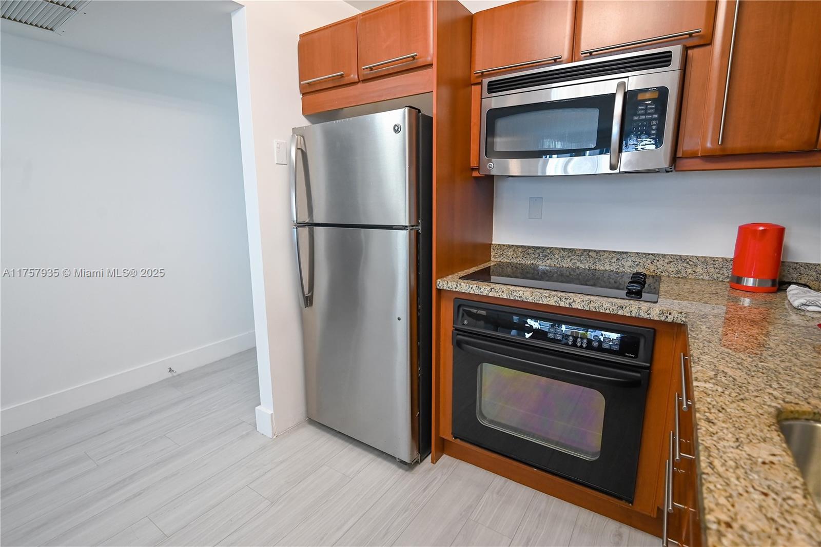 2301 Collins Avenue, Unit 921 Miami Beach, FL 33139 - Photo 16 of 45 a kitchen with a stove and a microwave