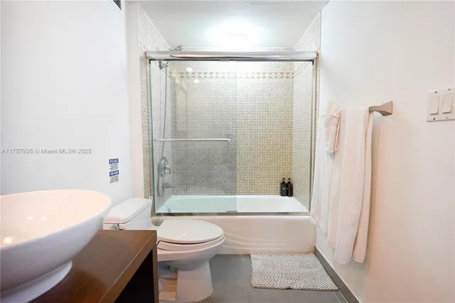a bathroom with a shower a bathtub and a toilet