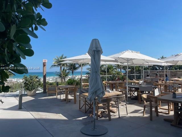 2301 Collins Avenue, Unit 921 Miami Beach, FL 33139 - Photo 39 of 45 a patio with a table and chairs under an umbrella