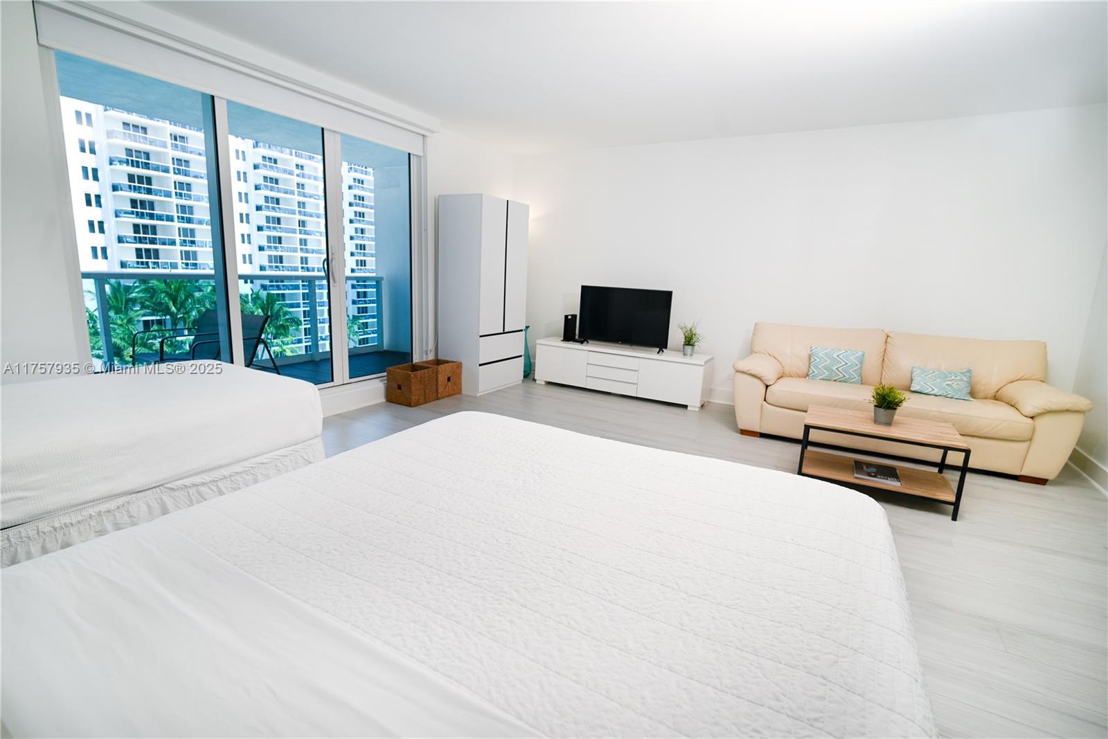 2301 Collins Avenue, Unit 921 Miami Beach, FL 33139 - Photo 8 of 45 a spacious bedroom with a bed and a large window