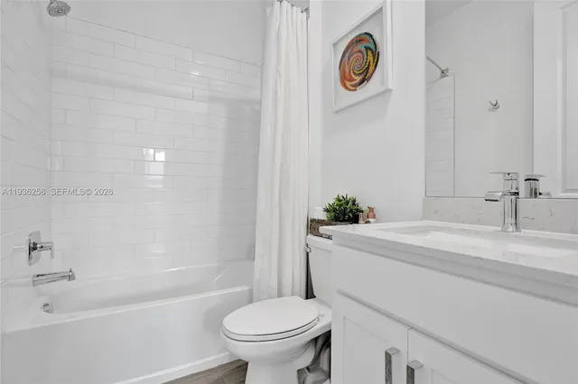 a bathroom with a sink a toilet and a bathtub