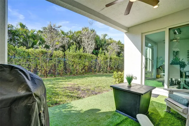 a view of a chairs in backyard of a house