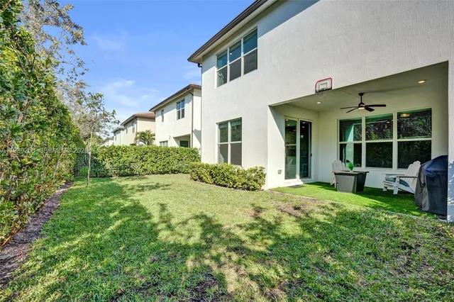 a view of a house with backyard sitting area and garden
