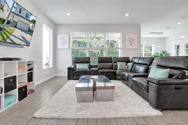 a living room with furniture and a large window